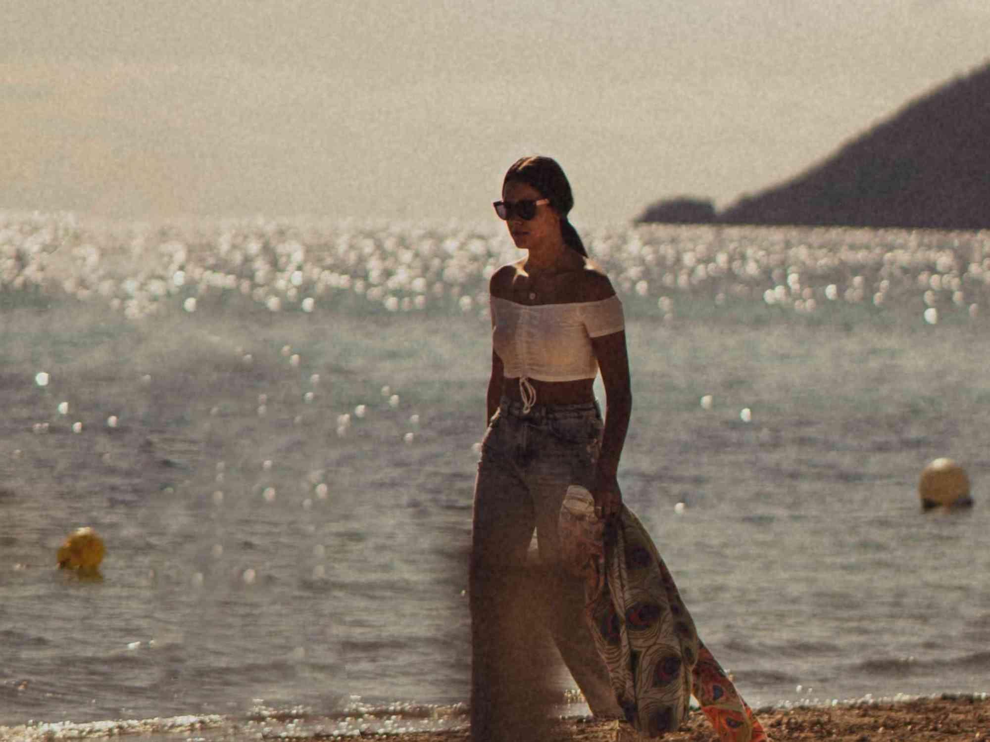 امرأة تمشي على الشاطئ
